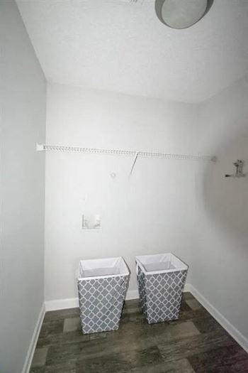 A bathroom with two baskets on the floor