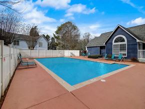 Decatur apartment for rent - a swimming pool with a house and a fence around it at The Sapphire, Decatur, GA, 30035
