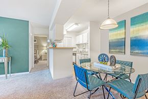 Columbia apartment for rent - A dining room with a glass table and blue chairs. at Grove at St. Andrews, Columbia