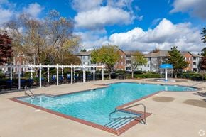 Villa Rica apartment for rent - A large swimming pool surrounded by a white fence and trees.