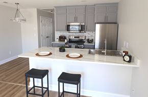 Moncks Corner apartment for rent - A kitchen with a white island and black stools.
