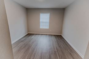 Georgetown apartment for rent - A room with wooden flooring and a window with blinds.