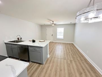Moncks Corner apartment for rent - A kitchen with a white countertop and wooden flooring.