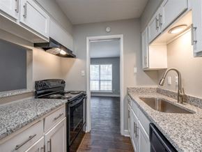 Indianapolis apartment for rent - a kitchen with white cabinets and a sink and a stove