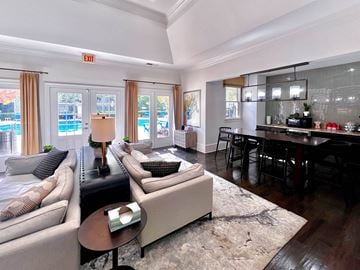 Kennesaw apartment for rent - a living room with a couch and a table in front of a dining room table