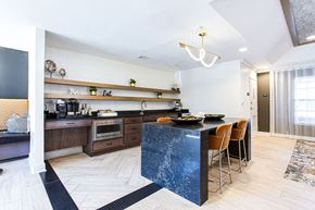 Gainesville apartment for rent - a kitchen with a blue counter top and a table with chairs at Indigo Apartments Gainesville, Georgia