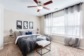 Gainesville apartment for rent - a bedroom with a bed and a ceiling fan at Indigo Apartments Gainesville, Gainesville, GA 30504