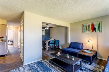 Thornton apartment for rent - A living room with a blue couch and a coffee table.