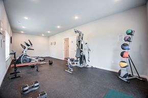 Lexington apartment for rent - A gym with a variety of equipment including weights and exercise machines.