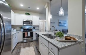 Lexington apartment for rent - A modern kitchen with a stainless steel refrigerator and a granite countertop.