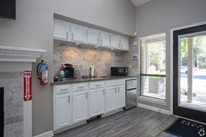 Greensboro apartment for rent - a kitchen with white cabinets and a sink and a window