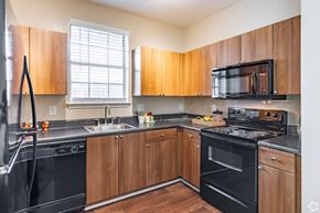 Lawrenceville apartment for rent - Overlook at Gwinnett Stadium Kitchen featuring custom cabinetry. Lawrenceville, GA.
