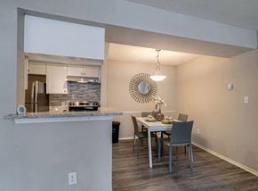 Atlanta apartment for rent - A modern kitchen with a dining table set for four.