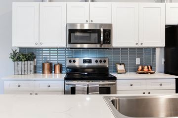 Hinesville apartment for rent - a kitchen with stainless steel appliances and white cabinets