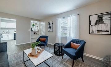 Smyrna apartment for rent - A living room with a blue chair and a coffee table.
