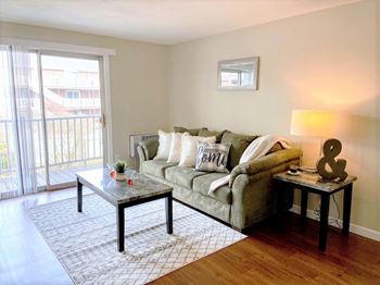 A living room with a couch and a sliding glass door