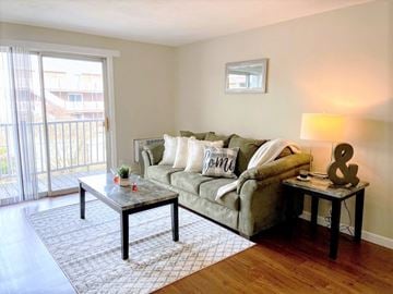 Chelmsford apartment for rent - a living room with a couch and a sliding glass door