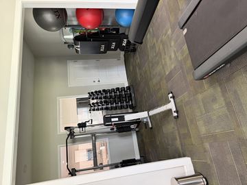 Augusta apartment for rent - A bathroom with a toilet, sink, and a weight machine.