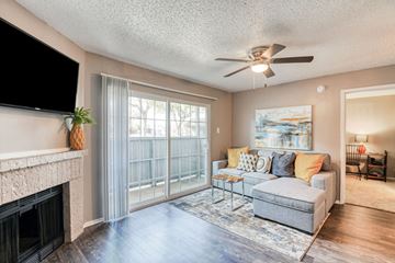 Arlington apartment for rent - A living room with a grey couch and a fireplace.