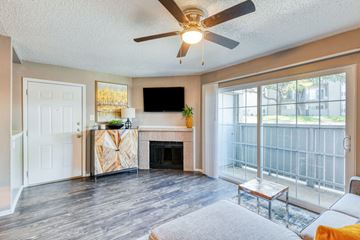 Arlington apartment for rent - A living room with a fireplace and a flat screen TV mounted on the wall.