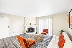 Shawnee Mission apartment for rent - A living room with a fireplace and a chair.