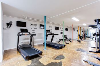A gym with treadmills and other exercise equipment