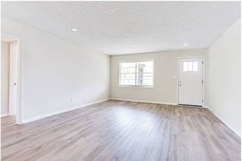 An empty room with a door and a window
