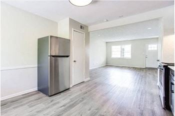 A kitchen with a refrigerator and a stove