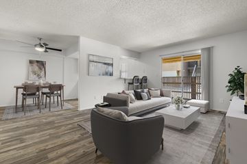Phoenix apartment for rent - A living room with a grey couch and a wooden floor.