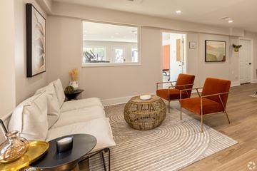 Shawnee Mission apartment for rent - a living room with a white couch and orange chairs