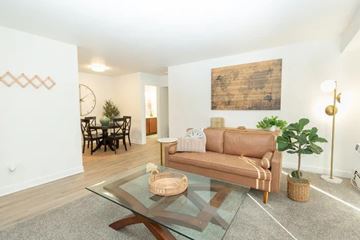 Madison apartment for rent - A living room with a brown sofa and a glass coffee table.