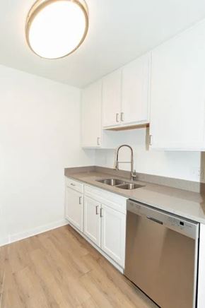 Madison apartment for rent - A kitchen with white cabinets and a wooden floor.