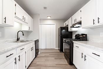 Modern galley style kitchen with white cabinetry