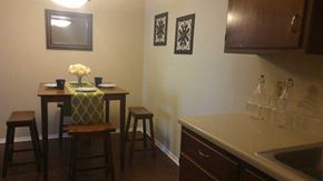 College Station apartment for rent - a kitchen with a table and chairs and a sink