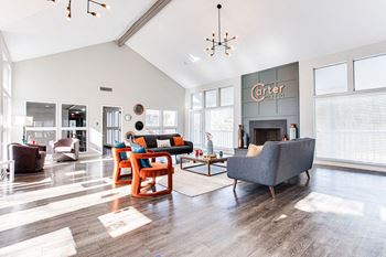 A living room with a grey couch and a fireplace