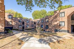 Kansas City apartment for rent - A courtyard surrounded by brick buildings on a sunny day.