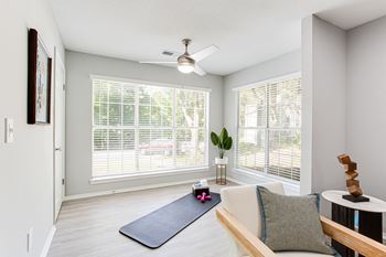 An empty living room with a yoga mat