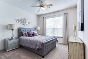 Snellville apartment for rent - a bedroom with a large window and a ceiling fan