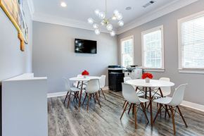 Snellville apartment for rent - a dining room with a table and chairs and a television on the wall