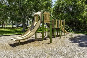 Rockledge apartment for rent - a slide on a playground in a park at Ventura at Turtle Creek, Rockledge, FL