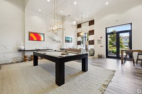 Destin apartment for rent - A room with a pool table and a painting on the wall.