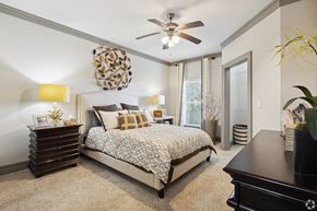 Destin apartment for rent - A bedroom with a bed, dresser, and ceiling fan.