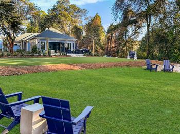 An expansive lawn with adirondack seating