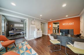Atlanta apartment for rent - A leasing office space with a desk, chairs, and a computer.