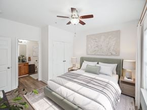Leland apartment for rent - A bedroom with a large bed and a ceiling fan.