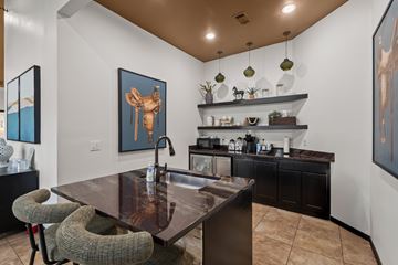 Mckinney apartment for rent - A modern kitchen with a brown table and black chairs.