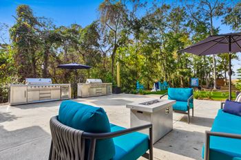 Patio with bbq grills, seating, and a fire pit