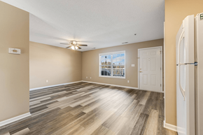 Asheville apartment for rent - an empty living room with a white door and a ceiling fan