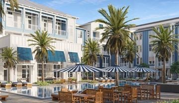 Pooler apartment for rent - A pool area with chairs and umbrellas in front of a building.
