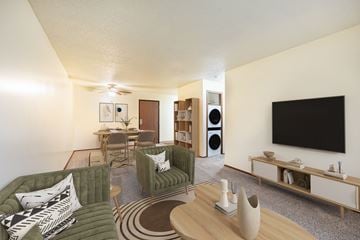 West Des Moines apartment for rent - A living room with a green couch and a television on the wall.